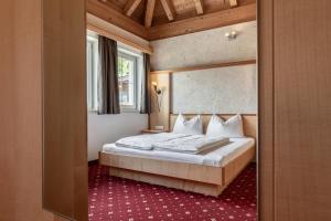a bedroom with a bed in a room at ALPENAPART Ladis - Premium Family Apartments in Ladis