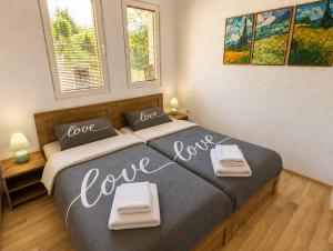 a bedroom with a bed with love written on it at Lake and Mountain Hideaway in Ohrid