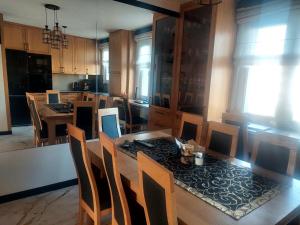 a kitchen with a table and chairs and a dining room at Apartament na Libelta in Wągrowiec