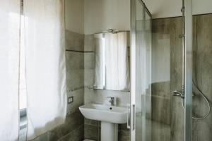 a bathroom with a sink and a shower at Aura Residence in San Biagio