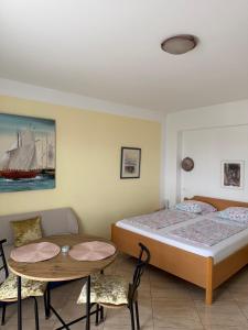 a bedroom with two beds and a table and chairs at Apartments Lončar in Gradac