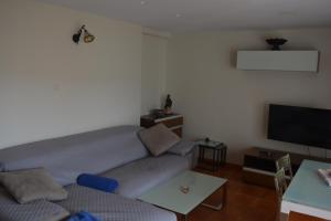 a living room with a couch and a flat screen tv at Casa Paola in Buñol