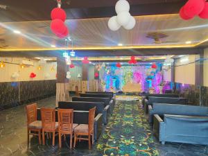 a banquet hall with chairs and a stage in the middle at Rao sahab hotel and restaurant in Etah