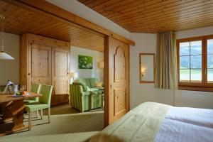 a bedroom with a bed and a desk and a chair at Hostellerie am Schwarzsee in Bad-Schwarzsee +29 photos