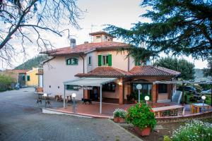 a large house with a table and a patio at La Tana Del Cinghiale in Tirli
