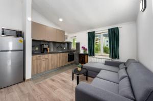 a living room with a couch and a kitchen at Apartment Tomic Makarska in Makarska