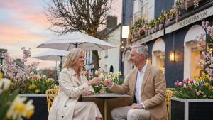 a man and woman sitting at a table with glasses of wine at The Blue Haven Hotel in Kinsale