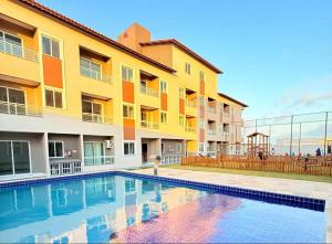 a swimming pool in front of a building at Grace Palace in Paraipaba