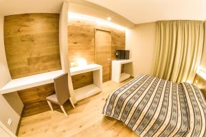 A bed or beds in a room at Grand Hotel Europa Rivisondoli Centro