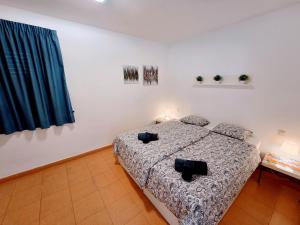 a bedroom with a bed with two black chairs at Wonderful Ocean View in Playa del Cura +33 photos