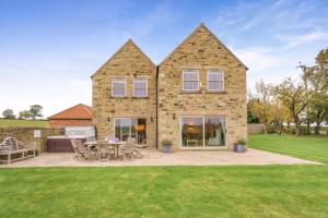 a house with a patio and a table and chairs at 4 Bed in Catterick oc-y33625 in Catterick Bridge
