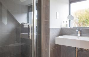 a bathroom with a sink and a shower at Cnoc Na Lobhta in Husabost +73 photos