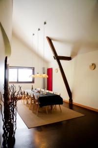 a dining room with a black table and chairs at Gîte Le Cot en Vallée d'Ossau in Sainte-Colome
