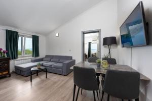 a living room with a couch and a table at Apartment Tomic Makarska in Makarska