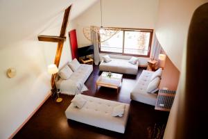 a living room with white furniture and a large window at Gîte Le Cot en Vallée d'Ossau in Sainte-Colome
