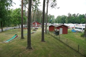 a park with a playground with trees and buildings at Bromölla Camping o Vandrarhem in Bromölla