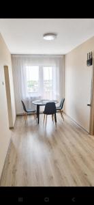 a dining room with a table and chairs in a room at Viktorija Apartament in Liepāja +13 photos