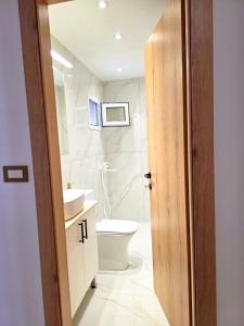 a bathroom with a toilet and a sink at Anthouli homes 4, steps from beach and centre in Kardamaina
