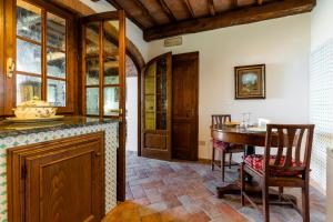 a kitchen with a table and a dining room at La finestra sul Chianti in Radda in Chianti +39 photos