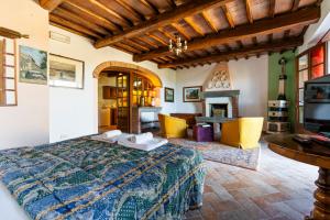 a bedroom with a bed and a living room at La finestra sul Chianti in Radda in Chianti