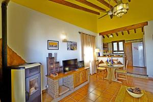a living room with a fireplace and a dining room at Villa El Regalo in Frigiliana