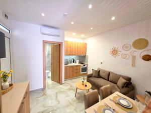 a living room with a couch and a table at Anthouli homes 4, steps from beach and centre in Kardamaina +17 photos