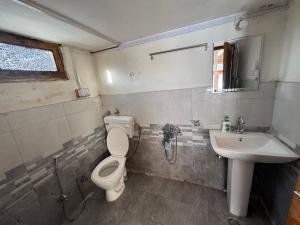 a bathroom with a toilet and a sink at Enter The Wild in Kalgha +78 photos