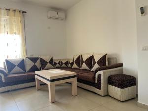 a living room with a couch and a coffee table at Katalea Apartment in Shëngjin