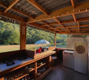 an outdoor kitchen with a view of a field at Glamping Luz Olive in Combret