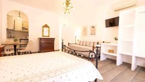 a bedroom with a bed and a dining room at Villa Frazeska in Kamares