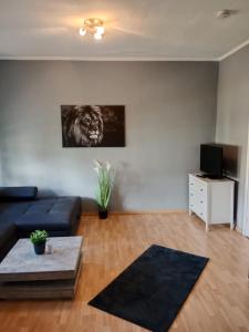 a living room with a couch and a television at Stadtnah an der Förde 65 2 in Flensburg