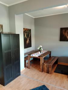 a living room with a table and a bench at Stadtnah an der Förde 65 2 in Flensburg +11 photos