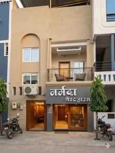 two motorcycles parked in front of a building at Narmada Gest House in Indore