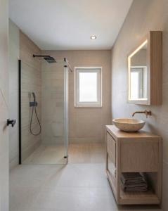 a bathroom with a sink and a shower at Villa JAM in Kaštela