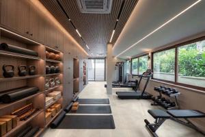 a gym with treadmills and benches in a room at Villa JAM in Kaštela