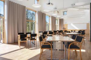 a conference room with tables and chairs and windows at Tylebäck Hotell & Konferens, BW Signature Collection in Halmstad