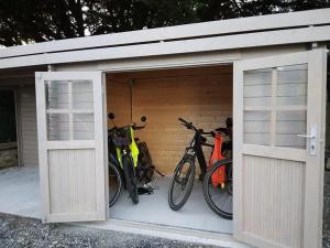three bikes are parked in a garage at LA Jacarandière in Le Cambout