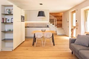 a kitchen and dining room with a table and chairs at Chalet Ca' la Fratela in Malcesine +18 photos