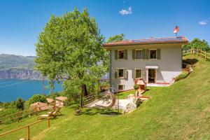 a house on a hill with a view of the water at Chalet Ca' la Fratela in Malcesine