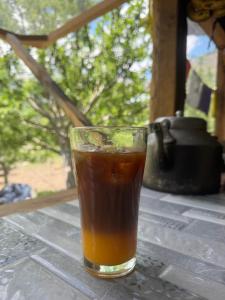 a glass of tea sitting on top of a table at Enter The Wild in Kalgha