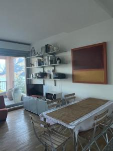 a dining room with a table and chairs in a room at Casa Bella Vista- Punta Gaeta San Siro CO in San Siro