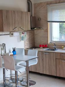 a kitchen with a table and chairs and a sink at Jones house in Nea Fokea +7 photos