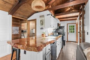 a kitchen with a large counter in the middle at Whispering Bass Lodge 3BDR in Kimberling City +21 photos