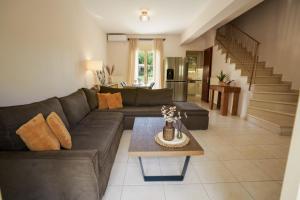 a living room with a couch and a table at Ithaki Apartments in Paramythia