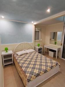 a bedroom with a large bed with two tables at Jones house in Nea Fokea