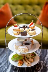 a three tiered plate of pastries on a shelf at Best Western Plus The Connaught Hotel and Spa in Bournemouth +106 photos