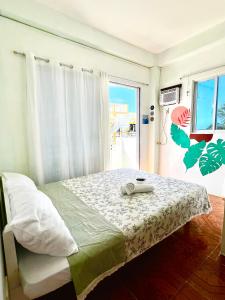 a bedroom with a bed with a phone on it at Bulan Guesthouse in San Isidro
