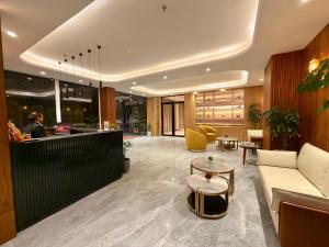 an office lobby with a couch and a table at ARNISA Kasauli - A Boutique Hotel in Kasauli