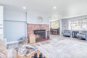 a living room with a fireplace with a couch and a table at Serendipity -A Happy Surprise Unit A in Oceanside +34 photos