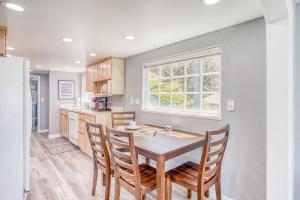 a kitchen with a table and chairs and a window at Serendipity -A Happy Surprise Unit A in Oceanside